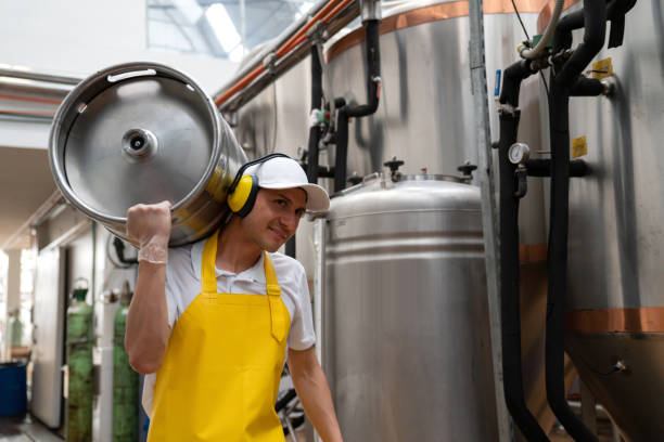 istock Worker carrying beer barrels at a brewery factory 1206641769