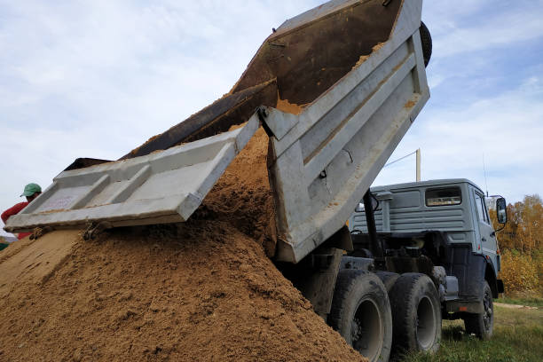 istock A dump truck unloads sand at a construction site to mix cement. 1206643532