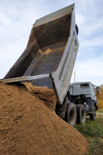 istock A dump truck unloads sand at a construction site to mix cement. 1206643536