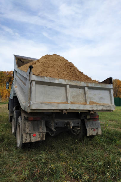 istock A dump truck unloads sand in the construction site. 1206643571