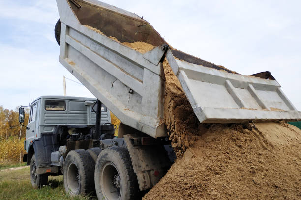 istock A dump truck unloads sand at a construction site to mix cement. 1206643572