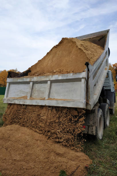 istock A dump truck unloads sand in the construction site. 1206643574