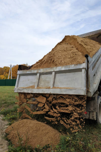 istock A dump truck unloads sand in the construction site. 1206643658