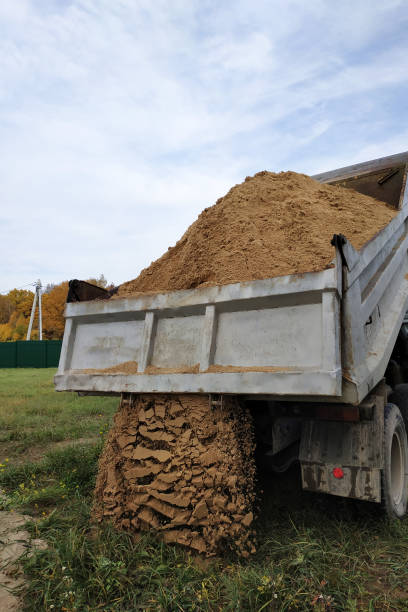 istock A dump truck unloads sand in the construction site. 1206643677