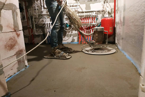 istock Sand-cement floor screed in a private house, the worker works with tools. 1206643743