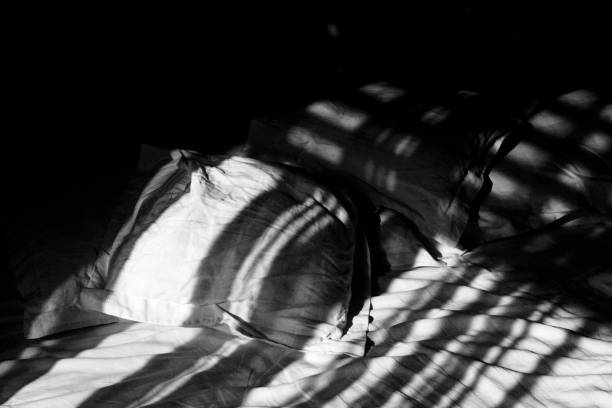 istock Bedroom scene with bedding and an open book bathed in morning light. 1206643749