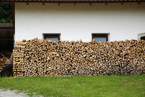 Rustic log firewood near the wall.