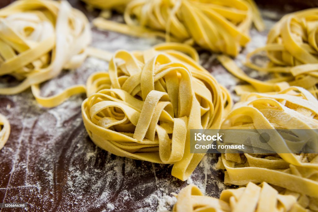 Homemade pasta on a wooden background. Italian style cuisine. Restaurant. Homemade pasta on a wooden background. Italian style cuisine. Restaurant. Background Pasta Stock Photo
