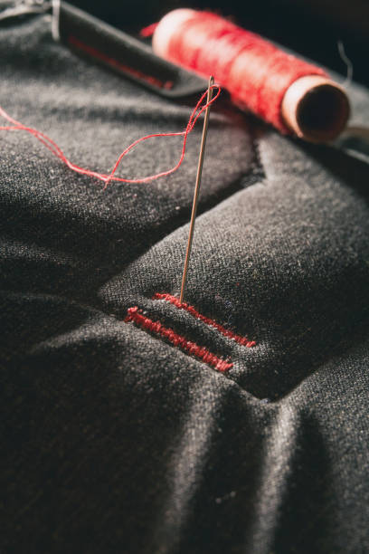 istock Red thread sewed on gray fiber 1206648800