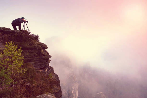 istock Photographer looking into mist through viewfinder 1206651040