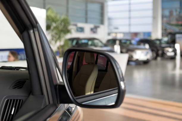 New cars at dealer showroom. Themed blur background with bokeh effect. New cars at dealer showroom. Themed blur background with bokeh effect. For use as a background. empty dealership interior stock pictures, royalty-free photos & images
