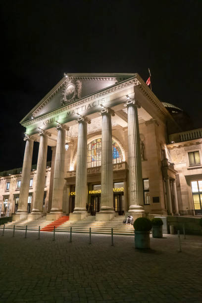 the Wiesbaden casino with famous entrance with roman pillars by night Wiesbaden, Germany - January 31, 2020:   the Wiesbaden casino with famous entrance with roman pillars by night. kurhaus casino stock pictures, royalty-free photos & images