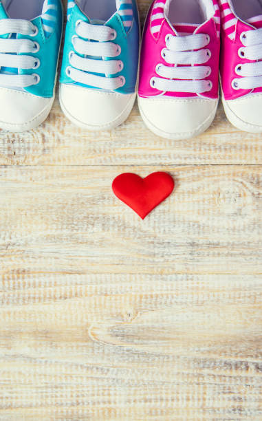 istock Baby booties and heart on a light background. Selective focus. 1206655846