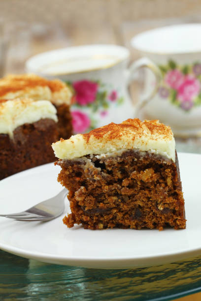 istock Delicious walnut and carrot cake with marzipan icing on white plate, closeup 1206656394