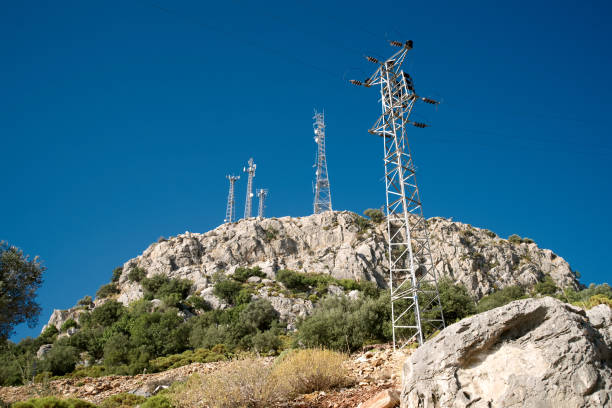 istock High voltage line and antennas by rocky mountain peak, electricity pylon, sunlight 1206657132