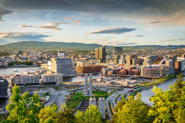 View from above Ekebergparken over Sorenga District towards Oslo Cityscape with Oslo Harbor in late afternoon light close to sunset. Oslo City, Norway, Scandinavia, Europe