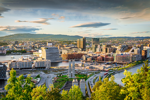 View from above Ekebergparken over Sorenga District towards Oslo Cityscape with Oslo Harbor in late afternoon light close to sunset. Oslo City, Norway, Scandinavia, Europe