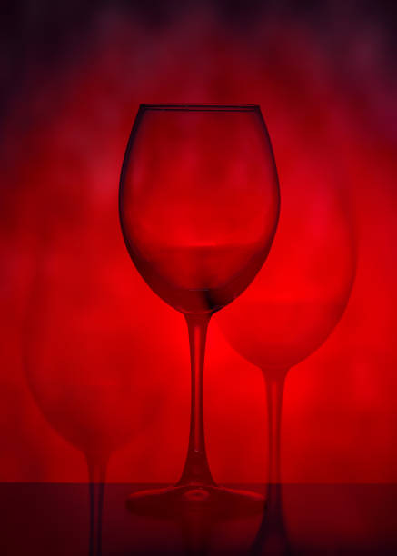 Wine glasses on a red background. Abstraction.