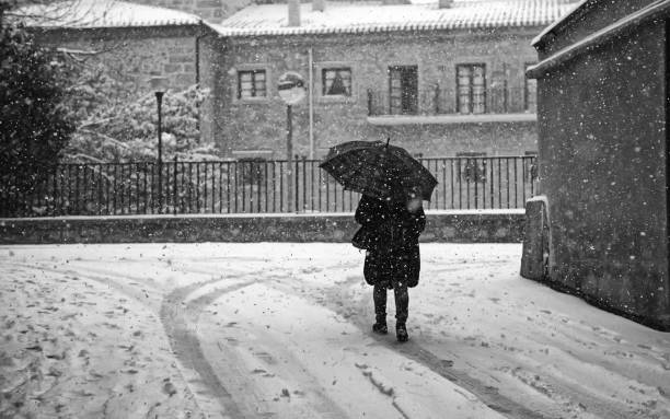 istock Woman walking in snow 1206660498