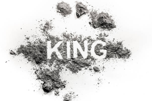 istock King word written in ash, dust or dirt as bad ruler or dictator downfall 1206661408