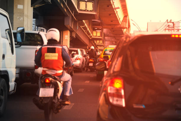 Traffic jam in the morning with sun light include motorcycles cars trucks with overpass stock photo