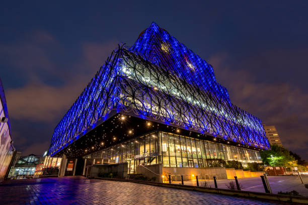 The lit library of Birmingham at night with its interesting architecture