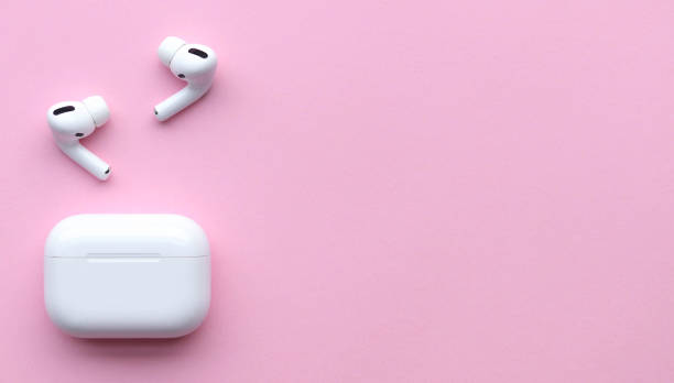 istock Wireless headphones on a pink background, space for text 1206661917