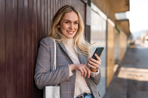 istock Young woman using a mobile phone outdoors stock photo 1206665400