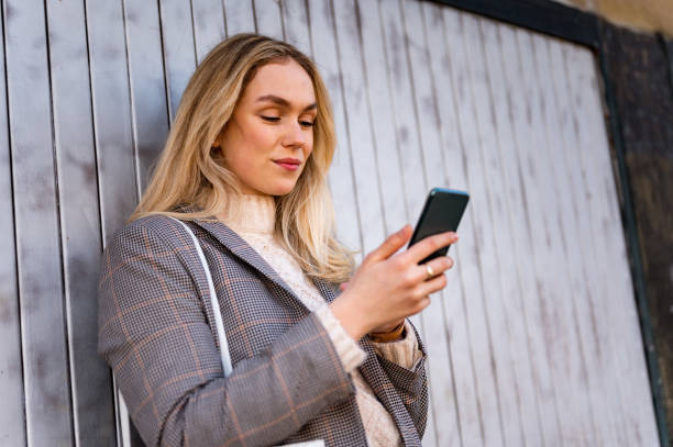 istock Young woman using a mobile phone outdoors stock photo 1206665500