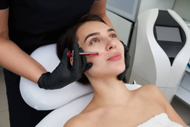 istock Beautiful woman gets an injection in her lips 1206665657