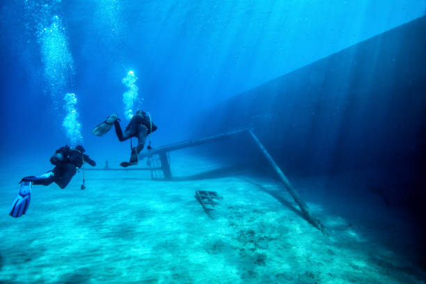 istock Scuba divers at wreck diving 1206666971