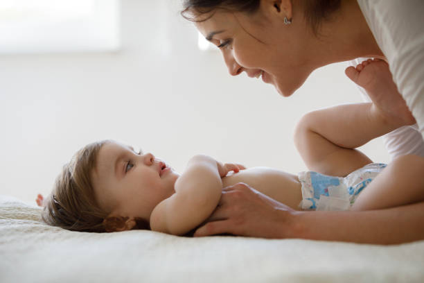 istock Mother and baby playing in the bed 1206669653