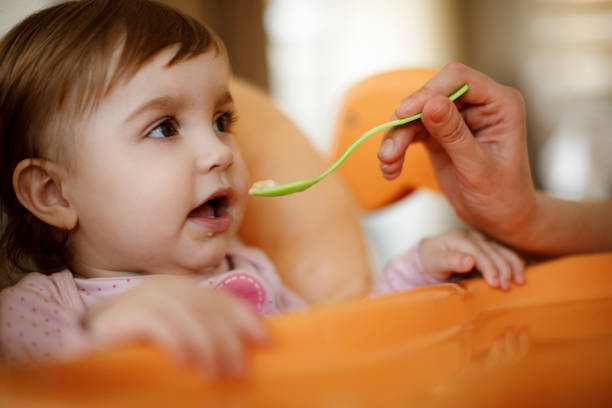 istock Mother feeding her baby 1206669714