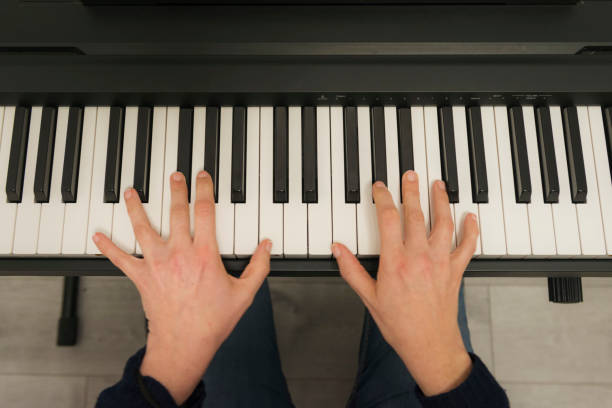 istock hands of a woman playing piano 1206669772