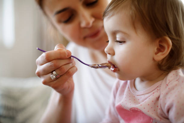 istock Mother feeding her baby 1206669807