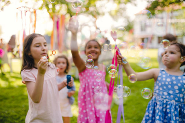 istock Small children standing outdoors in garden in summer, playing. 1206670037