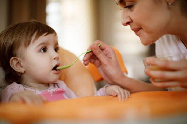 istock Mother feeding her baby 1206670087