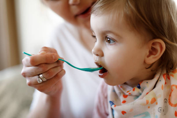 istock Mother feeding her baby 1206670116