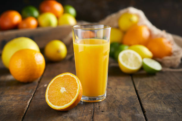 istock Orange juice in a glass with paper straw 1206671548