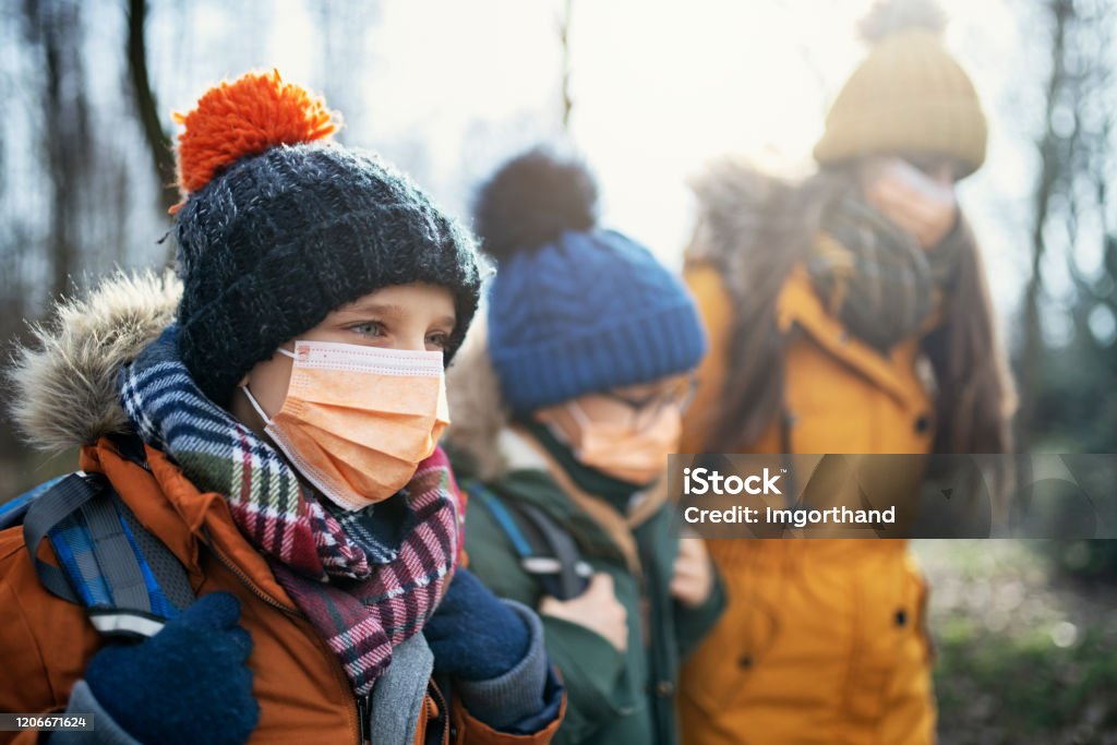 Three kids wearing anti virus masks going to school Three kids wearing anti virus masks. Kids are going to school. 
Shot with BMPCC4k with Q0 Raw Child Stock Photo