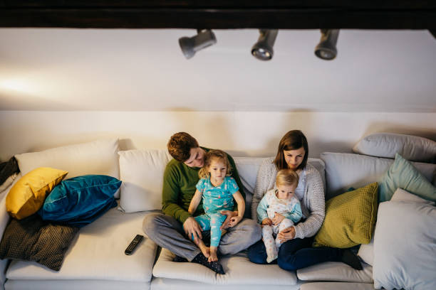 istock Young family watching tv. 1206672112
