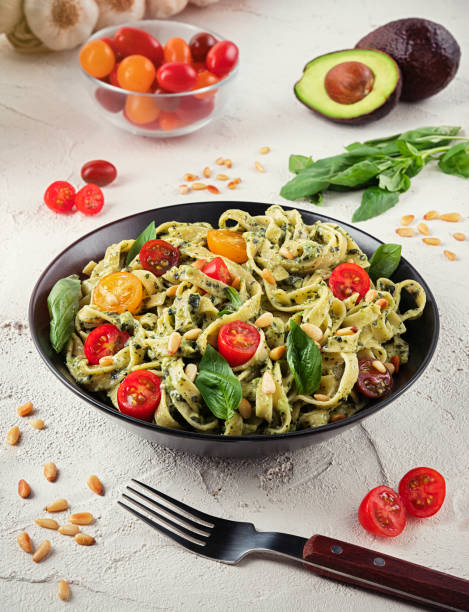 istock Pasta with pesto, basil, avocado and tomato 1206672802