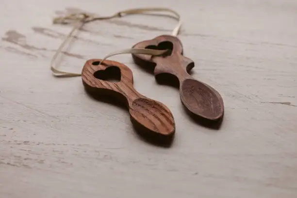 Traditional welsh wooden spoon in white background. Wooden love spoons from Wales. Handcrafts.