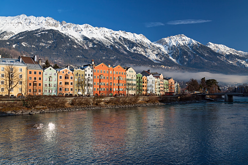 Panorama of Colourful Houses on Mariahilf Street along the Inn River at clear winter morning, Innsbruck, Austria