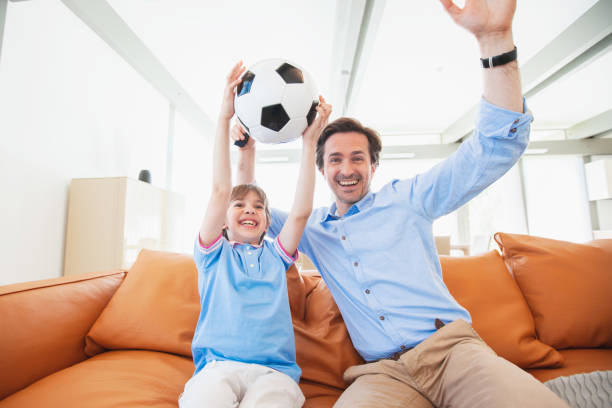 istock Father and son watching soccer 1206677237