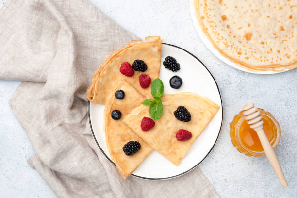 istock French Crepes With Summer Berries And Honey On Plate 1206677345