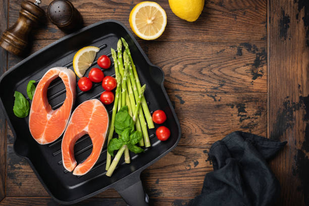 istock Uncooked salmon steaks and vegetables on a grill pan 1206678256