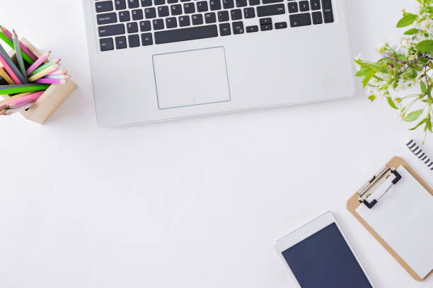 istock Flat lay blogger or freelancer workspace with a laptop, spring flowers, office supplies on a light background 1206678340