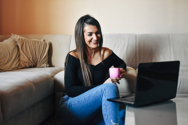 istock Young woman using laptop at home 1206678812