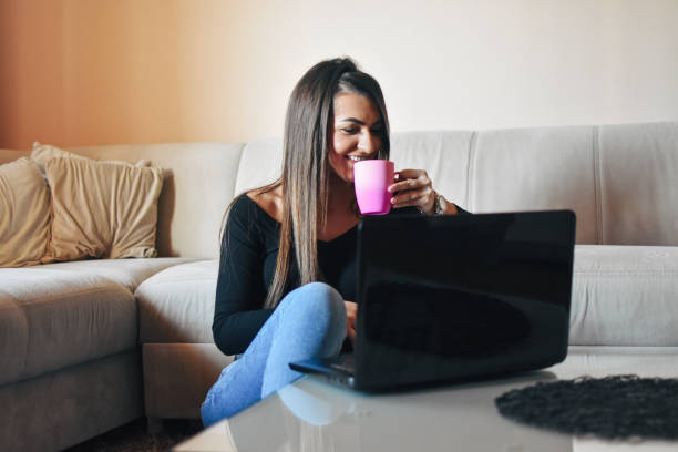 istock Young woman using laptop at home 1206680893